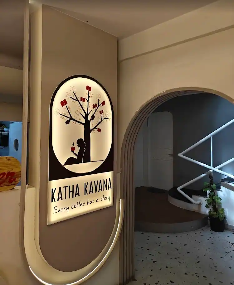 The painted house sign on a white interior wall next to a rounded arch doorway.
