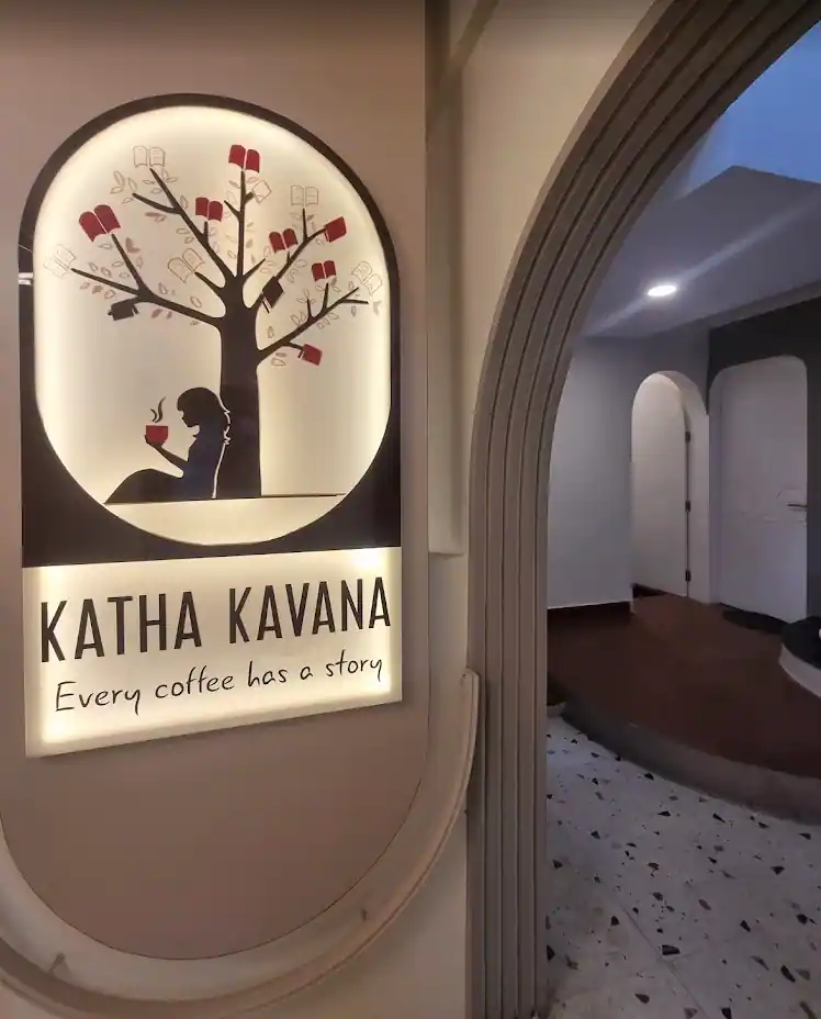 The house sign on a white wall with arch openings to either side and terrazzo running underfoot.